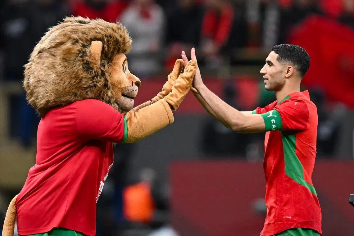 Morocco captain and defender Achraf Hakimi celebrating with the Atlas Lions' mascot after the Africa Cup of Nations semi-final shoot-out win over Nigeria at the Prince Moulay Abdellah stadium in Rabat on Jan 14, 2026.