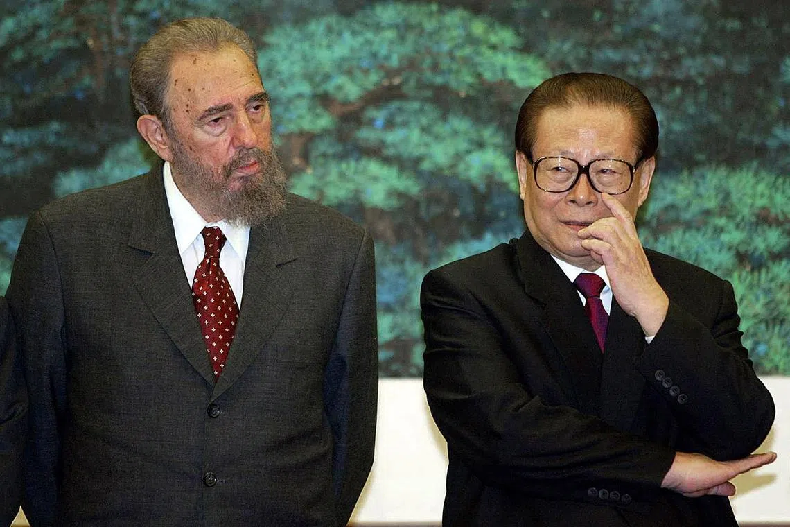 This file photo taken on Feb 27, 2003, shows Chinese President Jiang Zemin (R) looking on with visiting Cuban President Fidel Castro during a signing ceremony at the Great Hall of the People in Beijing. 