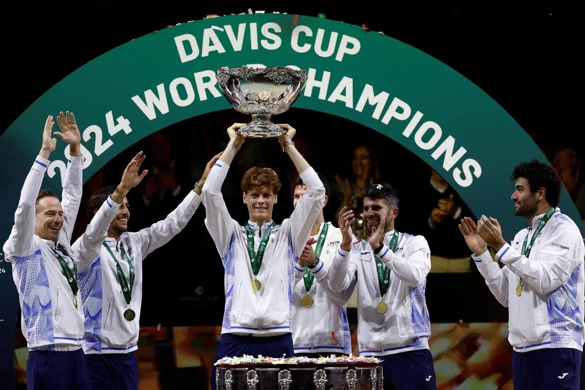 Italy's Jannik Sinner celebrates with the trophy after winning the Davis Cup Finals.
