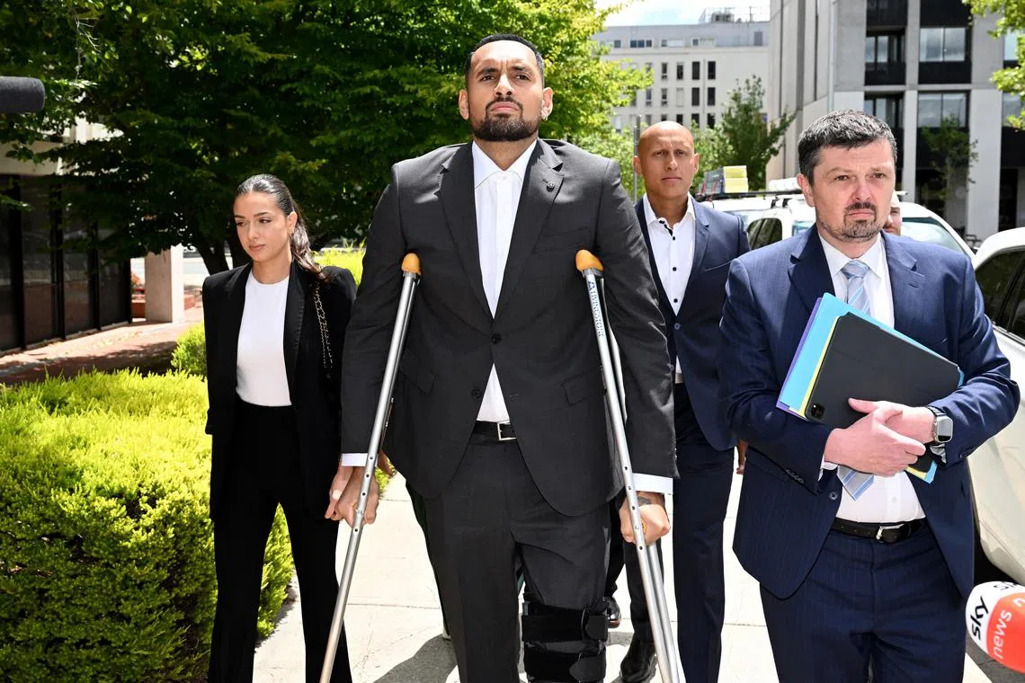 Tennis player Nick Kyrgios (on crutches) arriving at the Australian Capital Territory Magistrates Court in Canberra, Australia, on Friday.