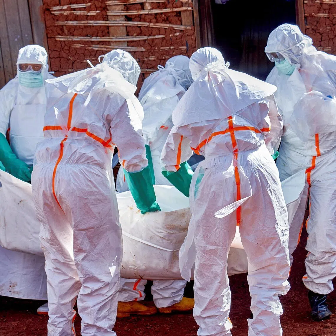 Red Cross workers retrieve the body of a man who died of Ebola in Ituri province, in the Democratic Republic of Congo.
