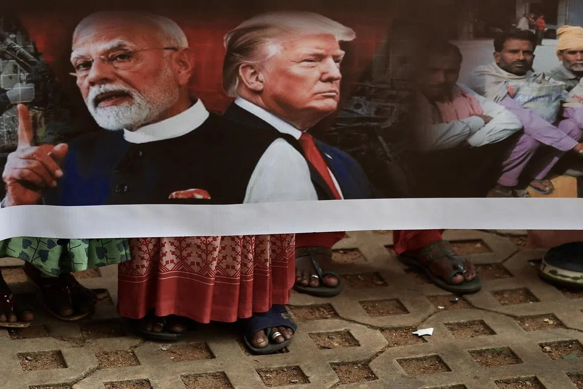Members of the All India Central Council of Trade Unions carry a banner during a protest against the United States and Trump administration's tariff policies in Bangalore, India, on Sept 1.