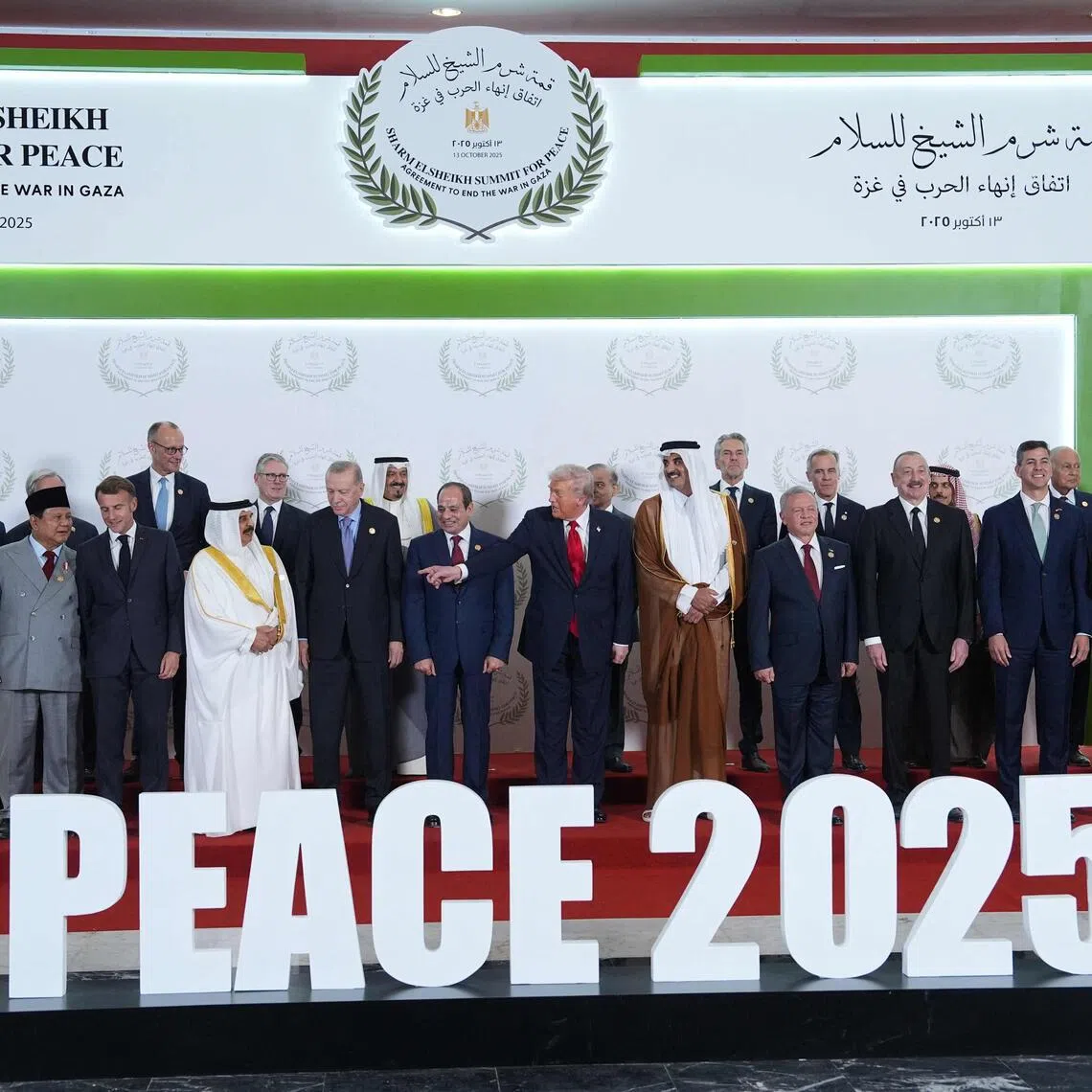 US President Donald Trump (centre) poses for a picture with world leaders during a summit on Gaza in Sharm el-Sheikh on Oct 13, 2025. 