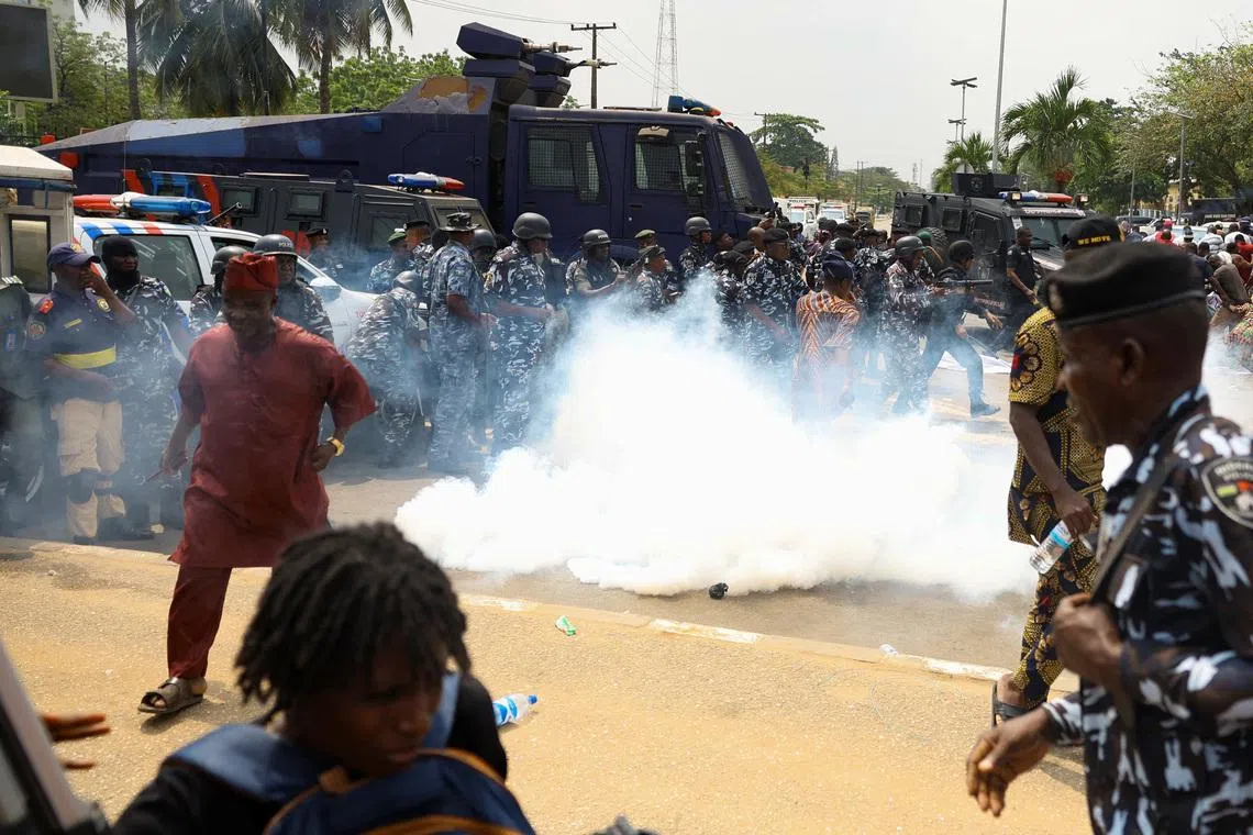 Members of the Nigerian police lob teargas canisters to disperse demonstrators during a protest by residents of Makoko riverine community over the demolition of their stilt houses in Lagos, Nigeria, January 28, 2026. REUTERS/Sodiq Adelakun