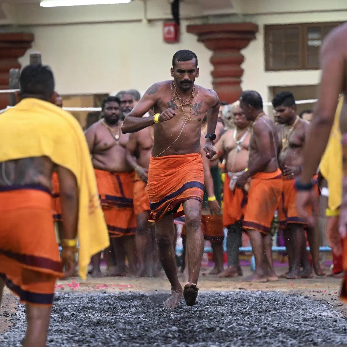 Devotees crossing the fire pit at Sri Mariamman Temple during the annual Theemithi Thiruvizha (Fire Walking Festival) on Oct 12, 2025.
ST PHOTO: AZMI ATHNI