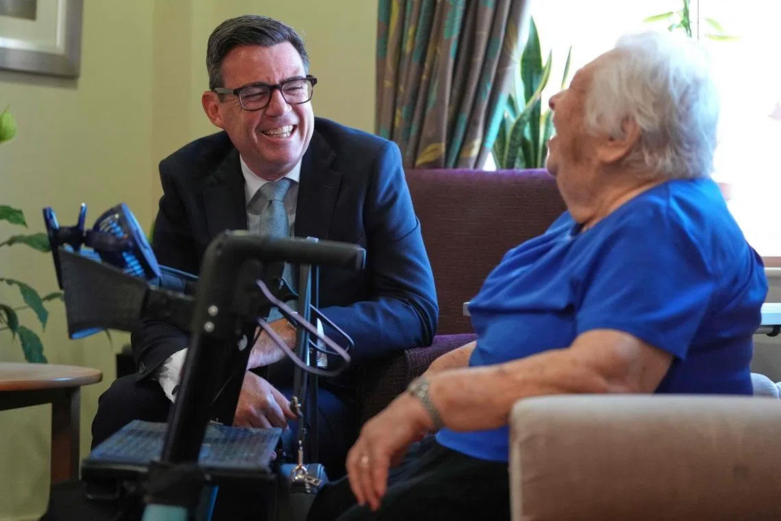 Britain’s Prime Minister Andy Burnham meets residents as he visits social care organisation Jewish Care in London on July 29.