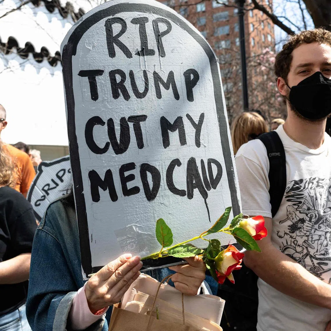 Activists protest efforts by the Trump administration to cut healthcare benefits.