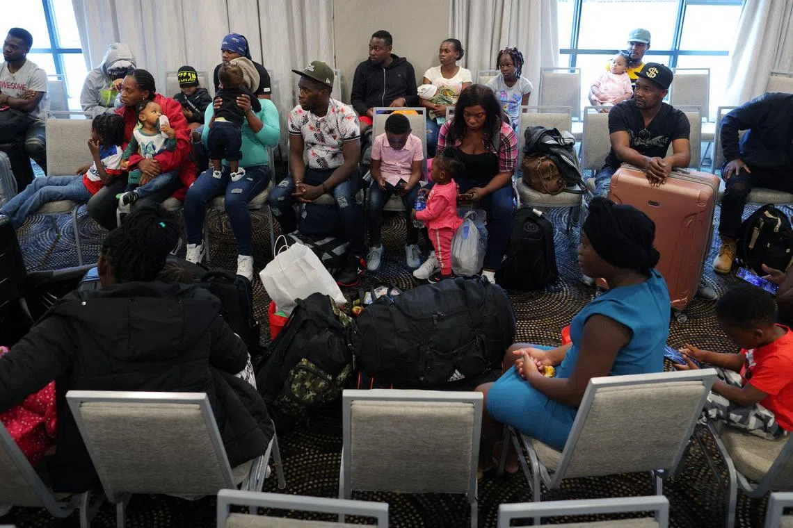 Immigrants from Haiti who recently arrived in Boston from other parts of the United States listen to instructions from representatives of La Colaborativa, a non-profit community services organization based in Chelsea, as they arrive at temporary housing in a hotel in Everett, Massachusetts, U.S., July 10, 2023.     REUTERS/Brian Snyder