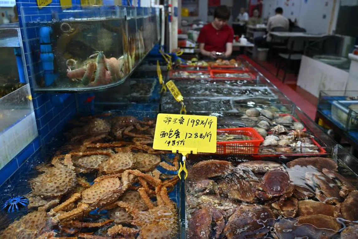 Crabs and shellfish are seen on sale at the Bashi seafood market in Xiamen, China’s southeastern Fujian province on April 28, 2025. (Photo by ADEK BERRY / AFP)