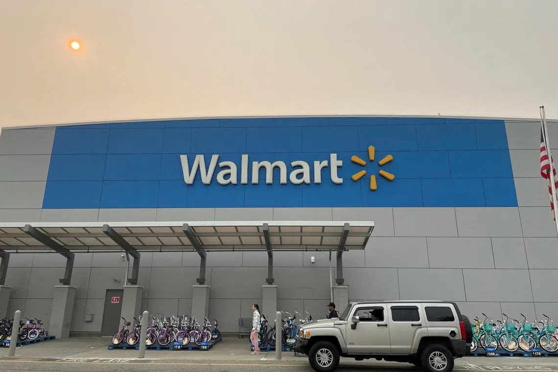 FILE PHOTO: A shopper leaves a Walmart Supercenter in Secaucus, New Jersey, U.S., June 7, 2023. The store is one of its newly remodeled locations. REUTERS/Siddharth Cavale/File Photo