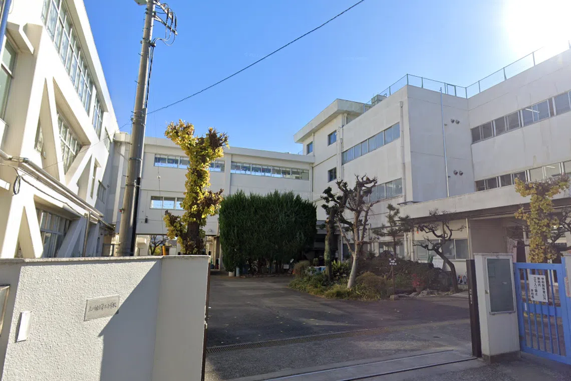 Five staff members were injured after two men intruded onto the premises of Tachikawa Daisan Elementary School on May 8.