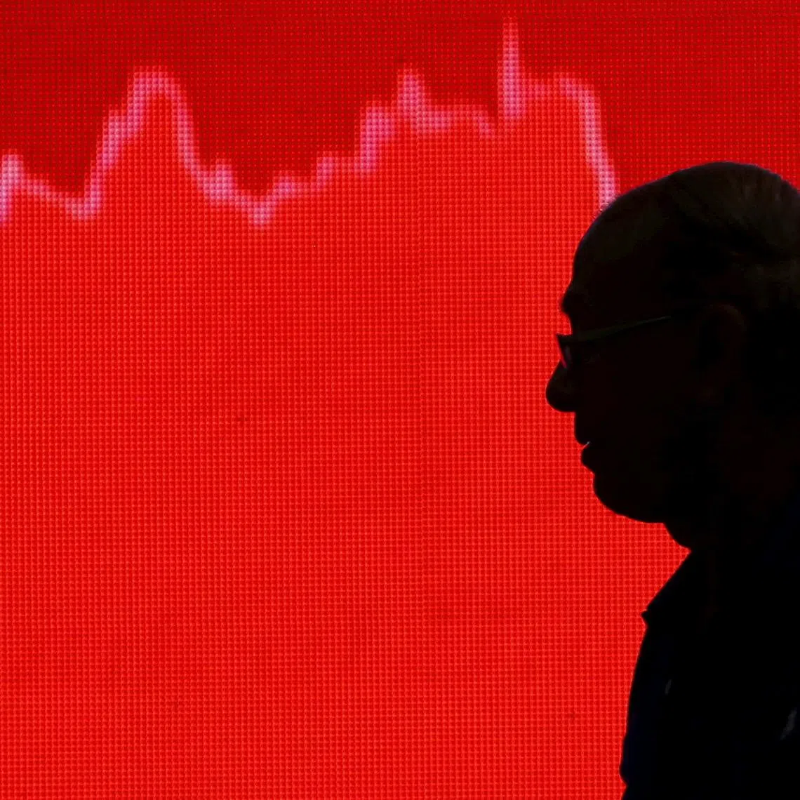 FILE PHOTO: A man looks at a screen displaying news of markets update inside the Bombay Stock Exchange (BSE) building in Mumbai, India, February 11, 2016. REUTERS/Danish Siddiqui/File Photo