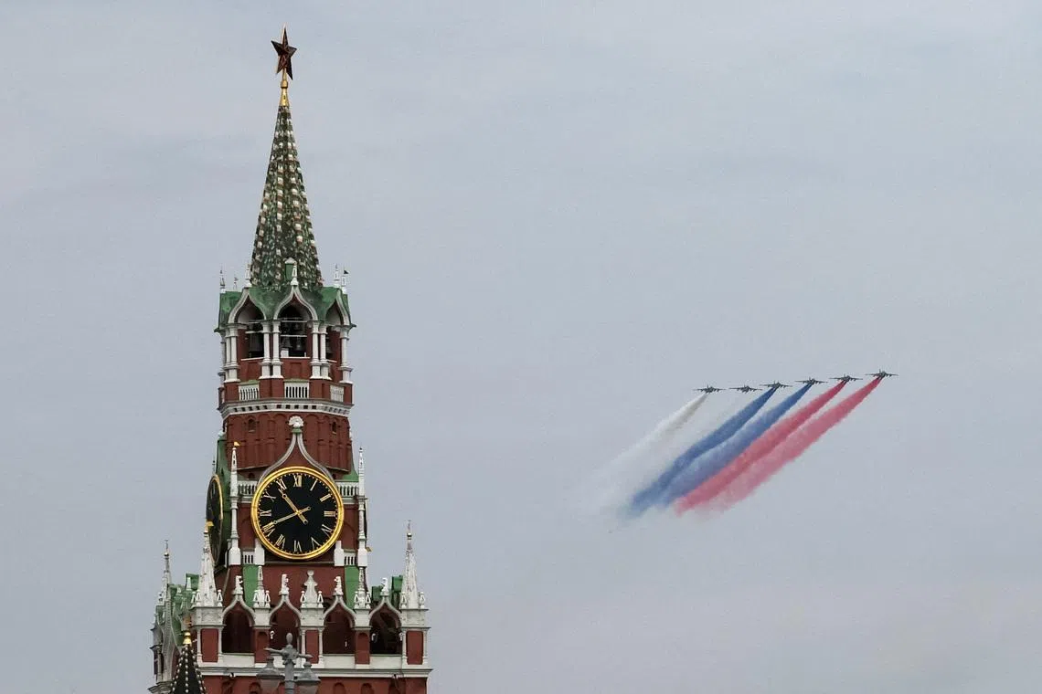 Russia's Su-25 jet aircraft release smoke in the colours of the Russian state flag while flying towards the Kremlin's Spasskaya Tower during a flypast rehearsal for a military parade, which marks the 81st anniversary of victory over Nazi Germany in World War Two, in central Moscow, Russia, May 6, 2026. REUTERS/Shamil Zhumatov