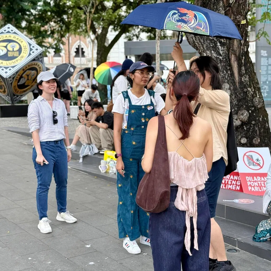 Activist Roshinee Mookaiah (middle, in blue) engaging supporters of her petition on April 18 on the need to ensure MPs attend Parliament.