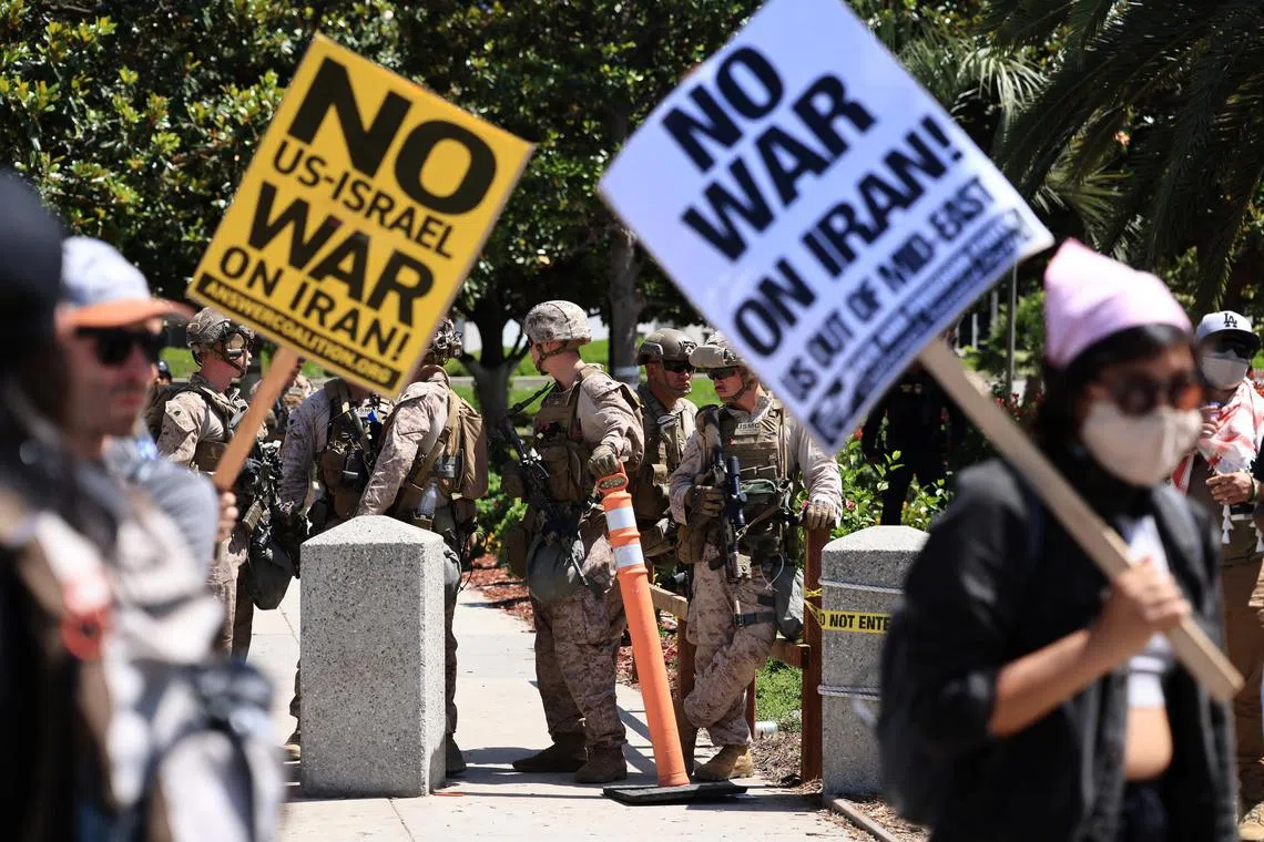 US Marines stand guard as demonstrators protest against the United States joining with Israel in attacks on Iran's nuclear facilities, at a federal building in Los Angeles, California, on June 22, 2025. 