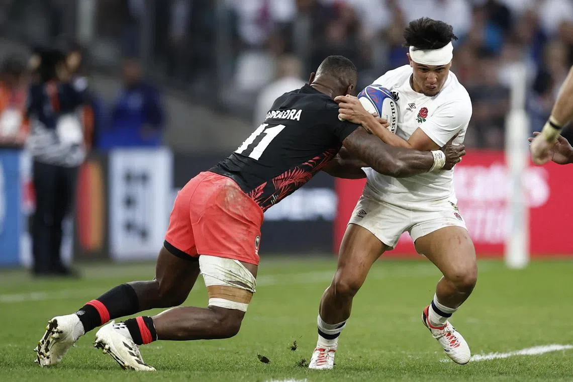 England's Marcus Smith in action with Fiji's Semi Radradra  during their Rugby World Cup quarter-final win on Oct 15.