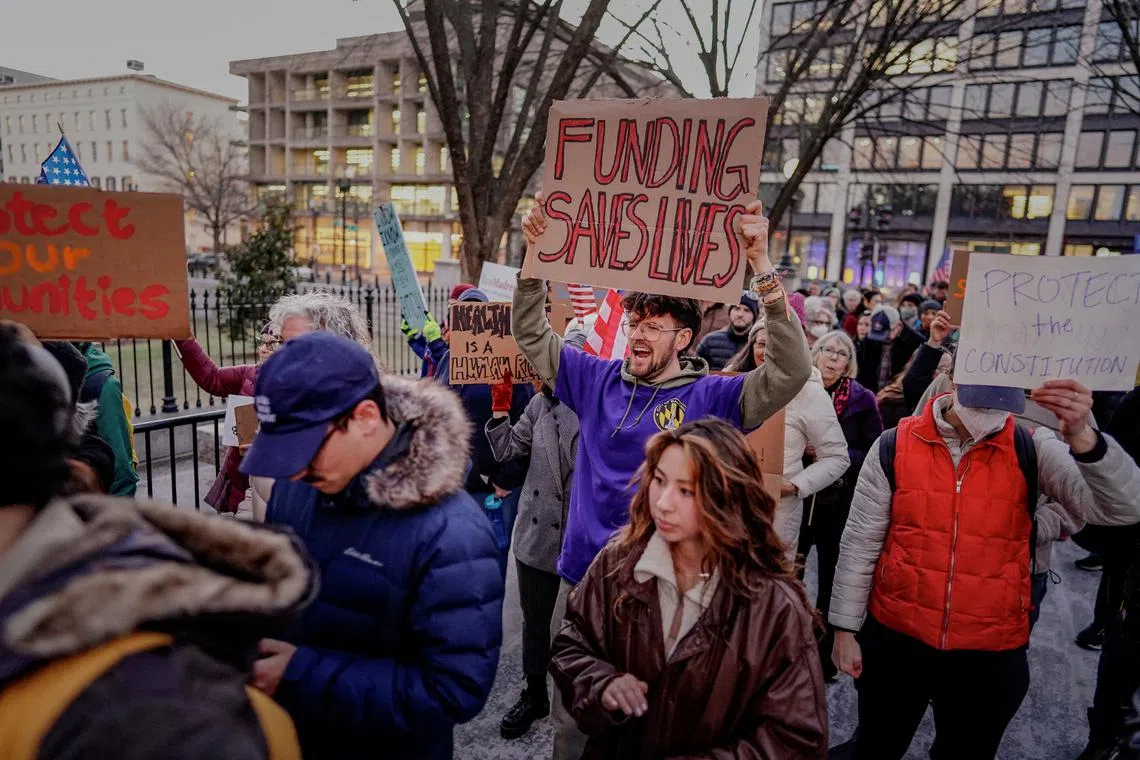 FILE PHOTO: People gather during a rally in support of federal funding and in opposition to U.S. President Donald Trump's order to pause all federal grants and loans, near the White House in Washington, U.S., January 28, 2025. REUTERS/Ken Cedeno/File Photo