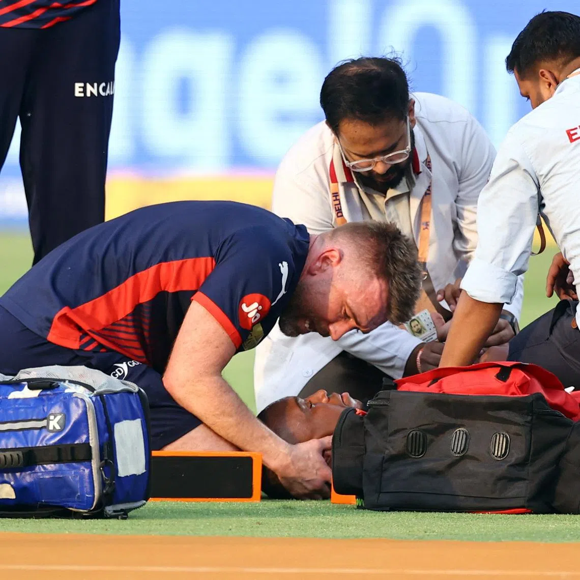 Cricket - Indian Premier League - IPL - Delhi Capitals v Punjab Kings - Arun Jaitley Stadium, New Delhi, India - April 25, 2026 Delhi Capitals' Lungi Ngidi receives medical attention after sustaining an injury REUTERS/Anushree Fadnavis