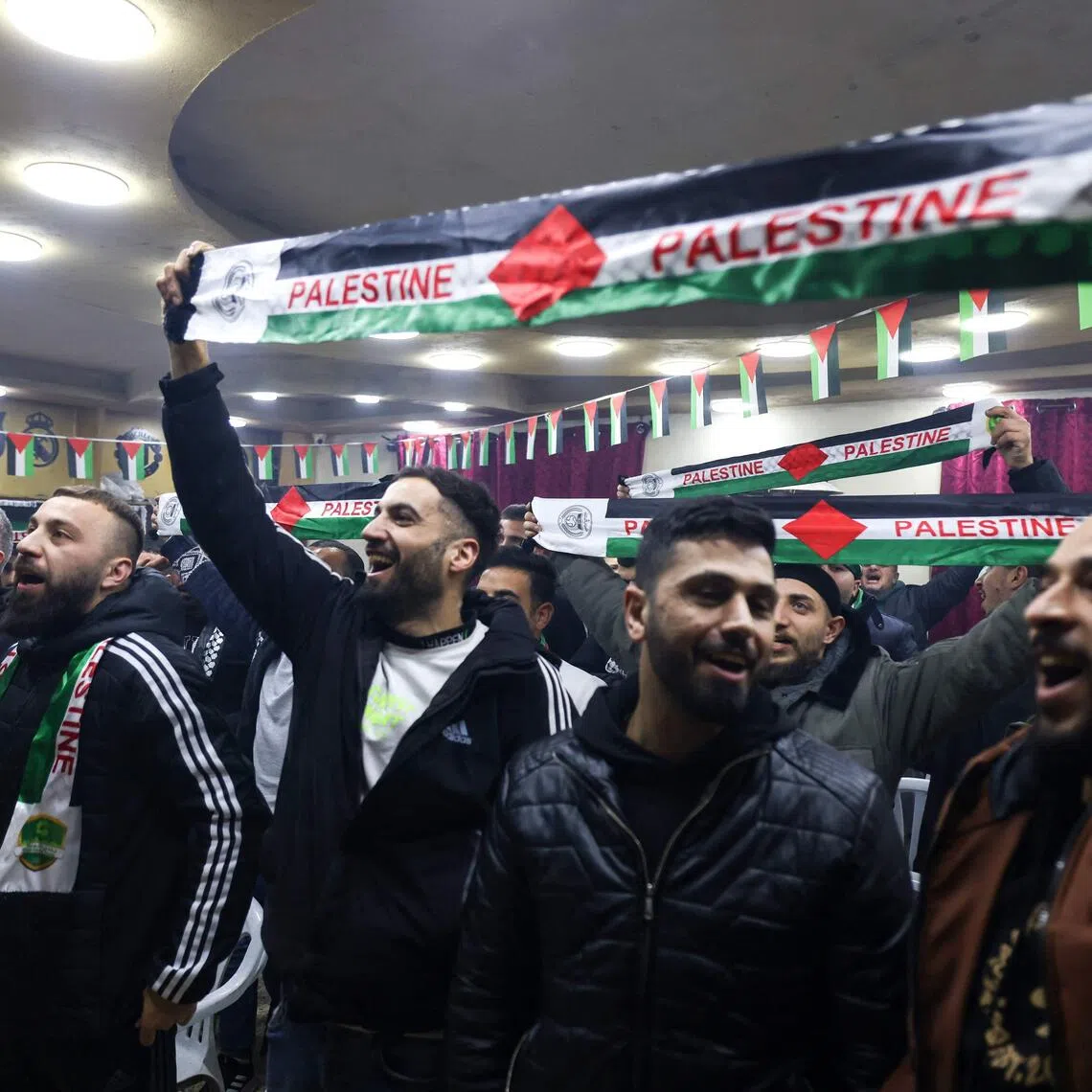 Palestinians in the occupied West Bank cheer as they watch their team play Saudi Arabia during the Fifa Arab Cup.
