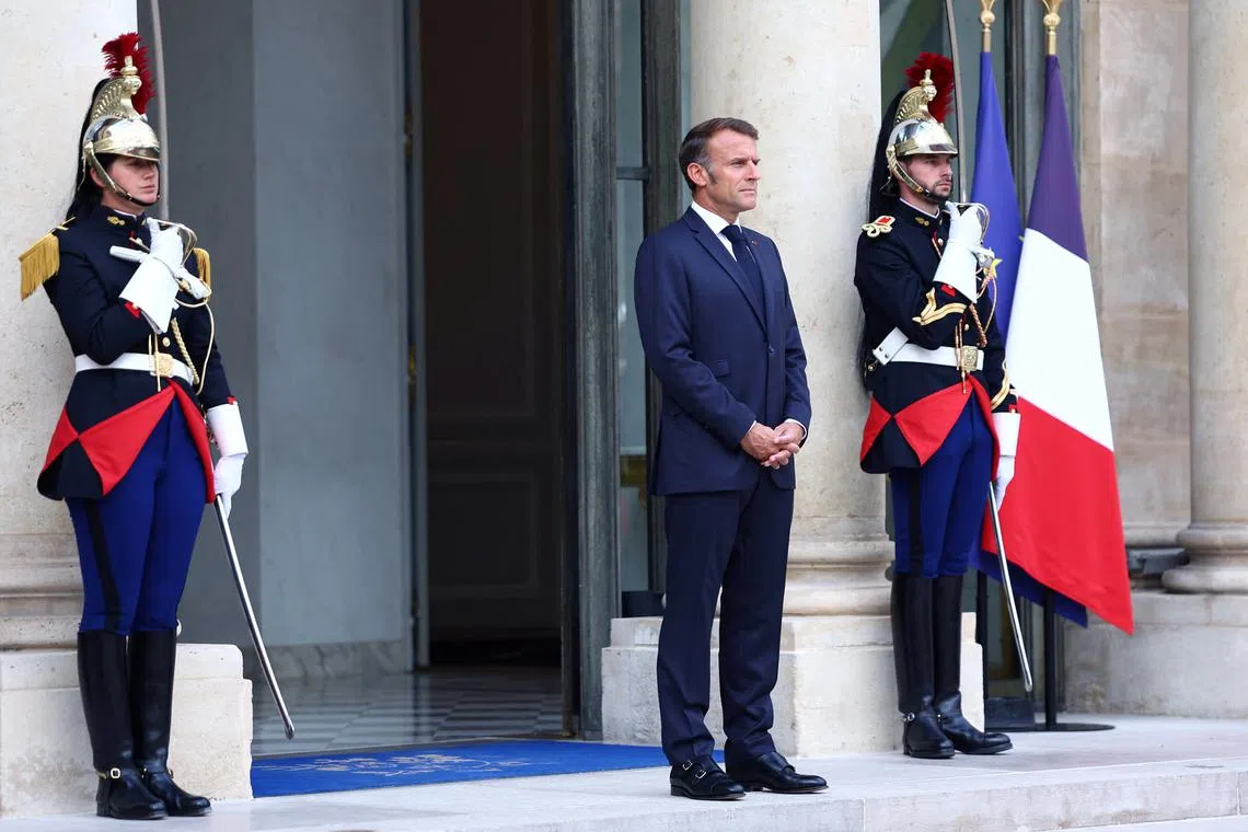 French President Emmanuel Macron waits for the arrival of a guest at the Elysee Palace in Paris, France, August 27, 2025. REUTERS/Abdul Saboor