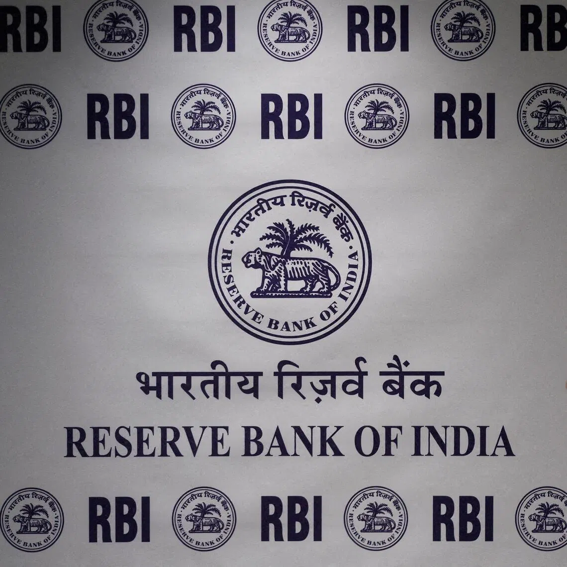 A man stands in front of the Reserve Bank of India logo inside its headquarters in Mumbai, India, on Feb 6.