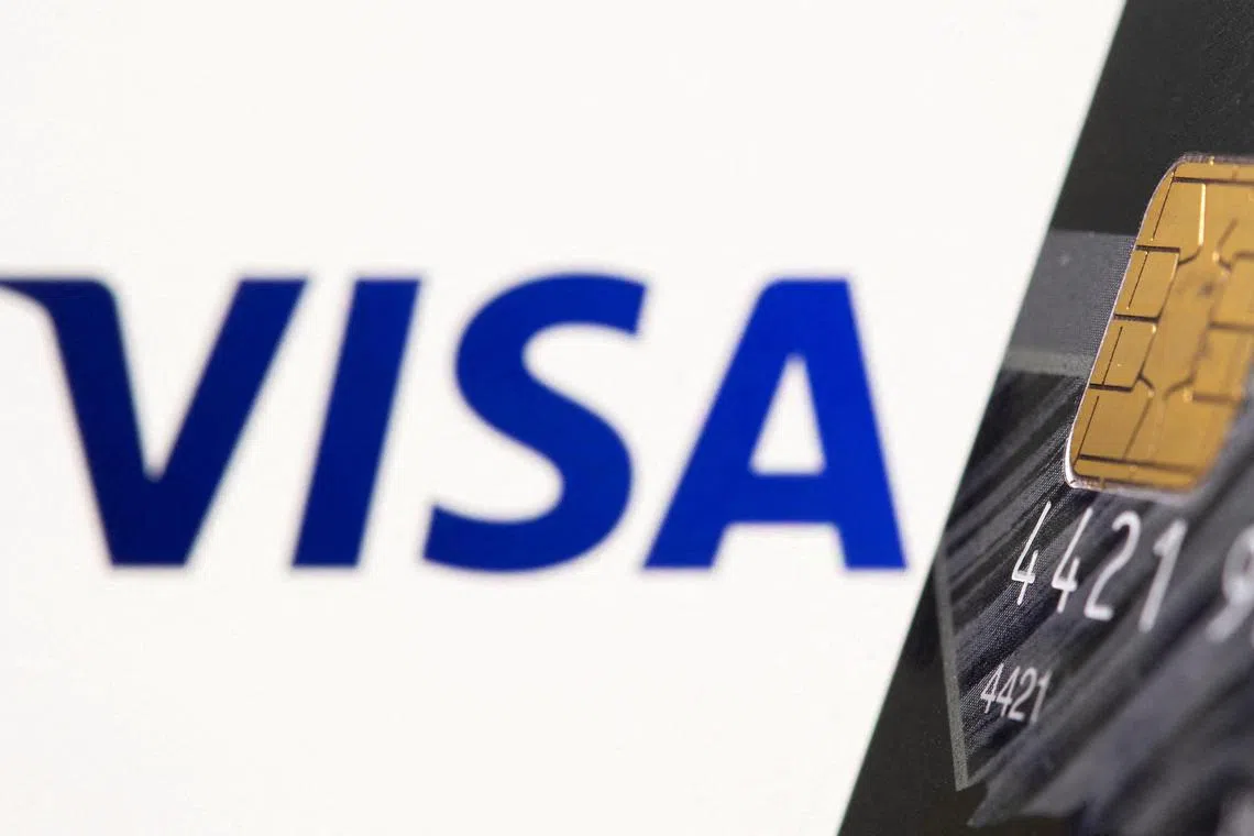 FILE PHOTO: FILE PHOTO: Credit card is seen in front of displayed Visa logo in this illustration taken, July 15, 2021. REUTERS/Dado Ruvic/Illustration/File Photo/File Photo