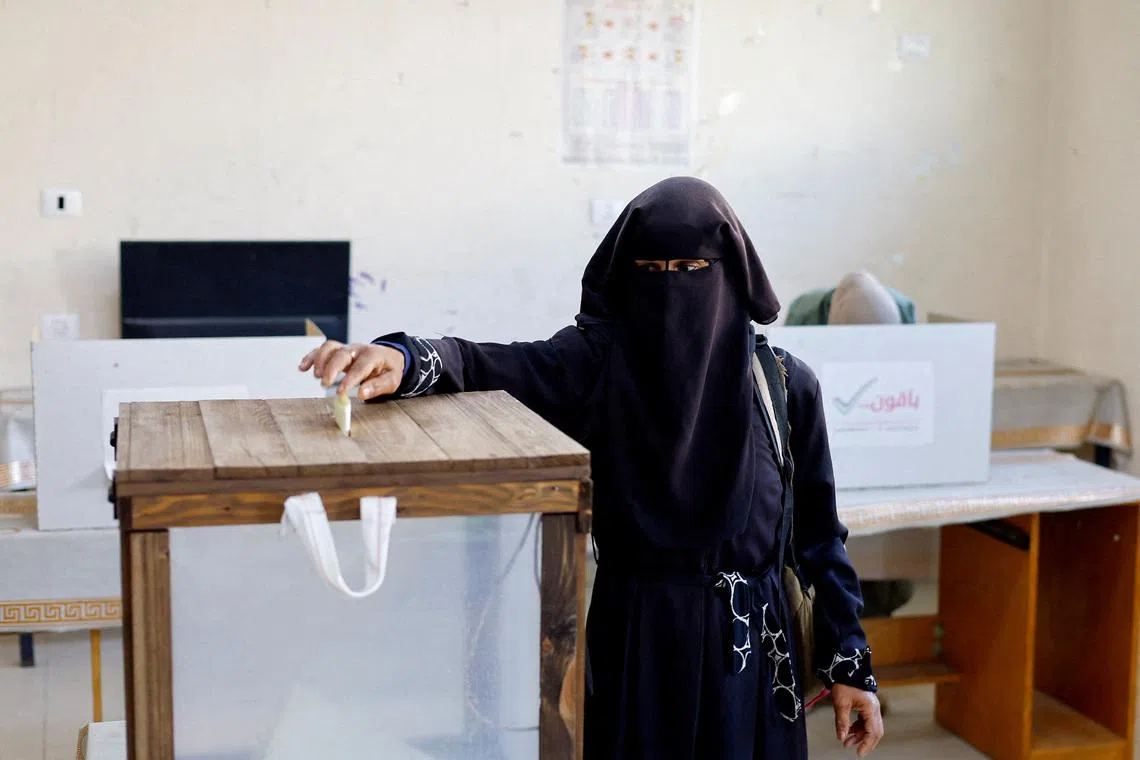 A Palestinian woman votes during the municipal election at a polling station in Deir al-Balah, central Gaza Strip April 25, 2026. REUTERS/Mahmoud Issa