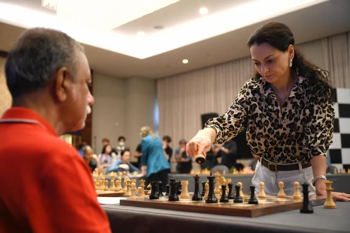 Russian-Swiss chess grandmaster Alexandra Kosteniuk plays an opponent during a 20-board tandem simultaneous exhibition held on the sidelines of the World Chess Championship 2024 on Dec 7, 2024.