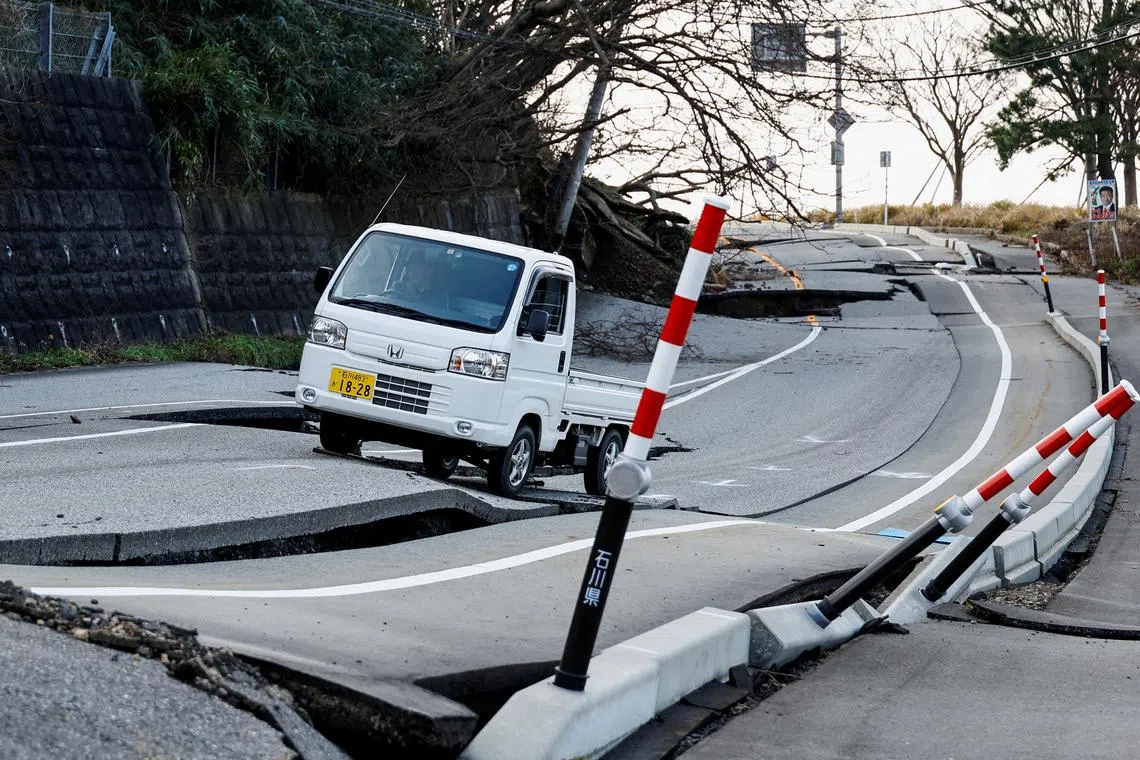 Nakamae driving his car on a damaged road as he heads to his town Soryomachi, which is isolated after the earthquake, in Wajima, Ishikawa Prefecture, Japan, Jan 6, 2024. 