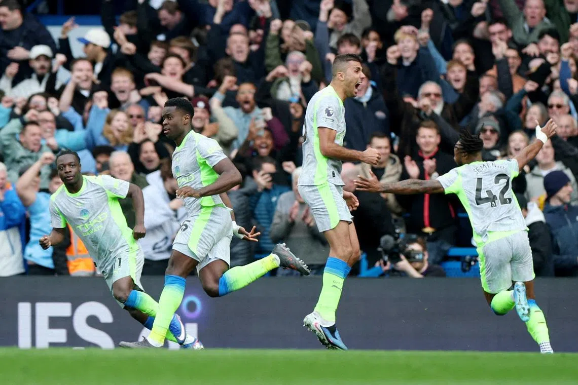 Soccer Football - Premier League - Chelsea v Manchester City - Stamford Bridge, London, Britain - April 12, 2026 Manchester City's Marc Guehi celebrates scoring their second goal with teammates REUTERS/Isabel Infantes
