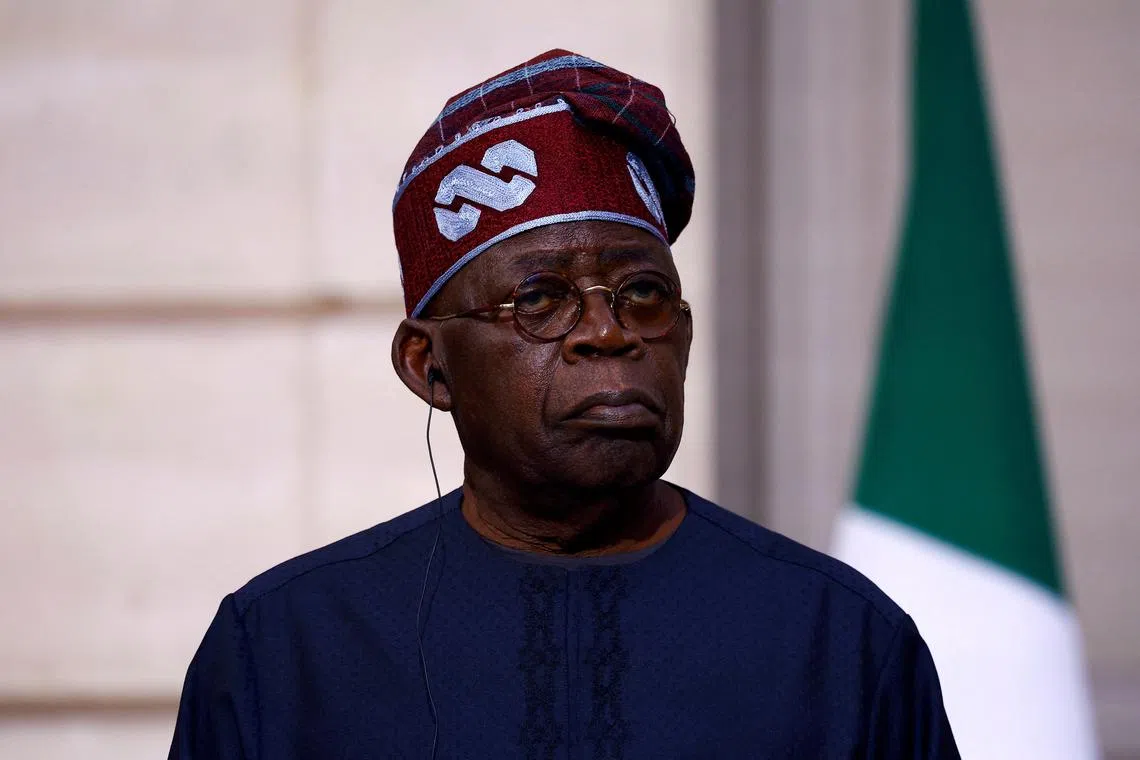 FILE PHOTO: Nigerian President Bola Ahmed Tinubu listens to French President Emmanuel Macron (not seen) as he delivers a statement to the press after a meeting at the Elysee Palace in Paris as part of his a two-day state visit to France, November 28, 2024. REUTERS/Sarah Meyssonnier/Pool/File Photo