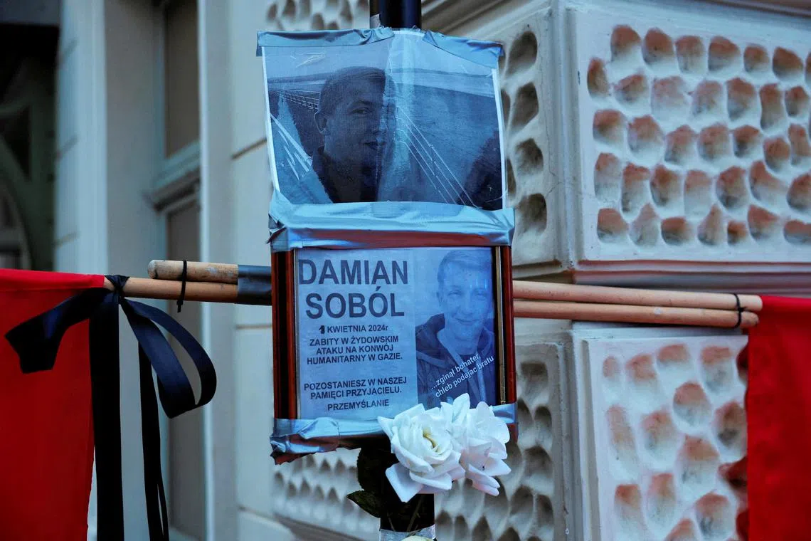 A picture of Damian Sobol is displayed as mourners gather to hold a vigil for the Polish aid worker Damian Sobol who was killed by the Israeli army in Gaza, among seven people working for the charity World Central Kitchen (WCK) who were killed in an Israeli airstrike, in Przemysl, Poland, April 4, 2024. Patryk Ogorzalek/ Agencja Wyborcza.pl via REUTERS ATTENTION EDITORS - THIS IMAGE WAS PROVIDED BY A THIRD PARTY. POLAND OUT. NO COMMERCIAL OR EDITORIAL SALES IN POLAND.