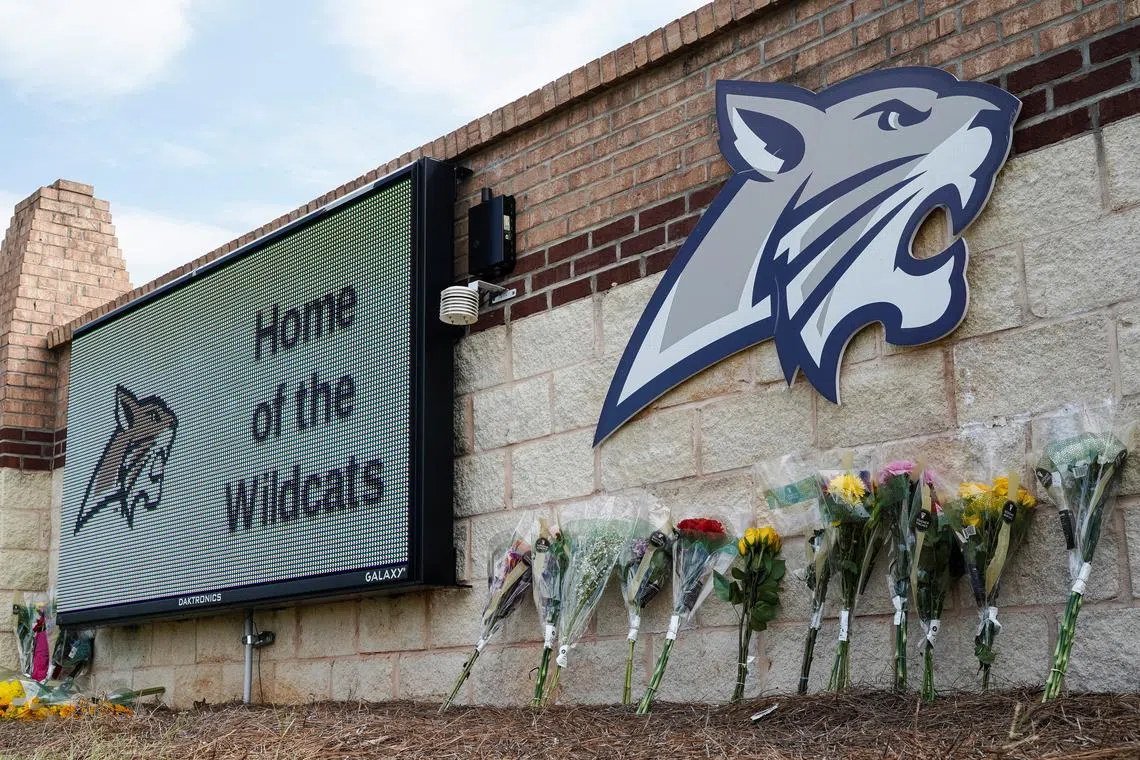 Flowers are seen at the Apalachee High School sign the day after a fatal shooting left four dead in Winder, Georgia, U.S. September 5, 2024. REUTERS/Elijah Nouvelage