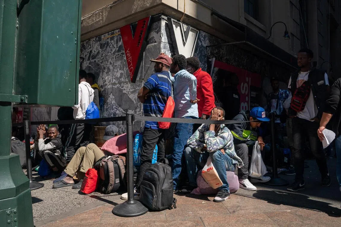 Migrants waiting to be processed in a queue outside of the Roosevelt Hotel in Manhattan on July 31.  