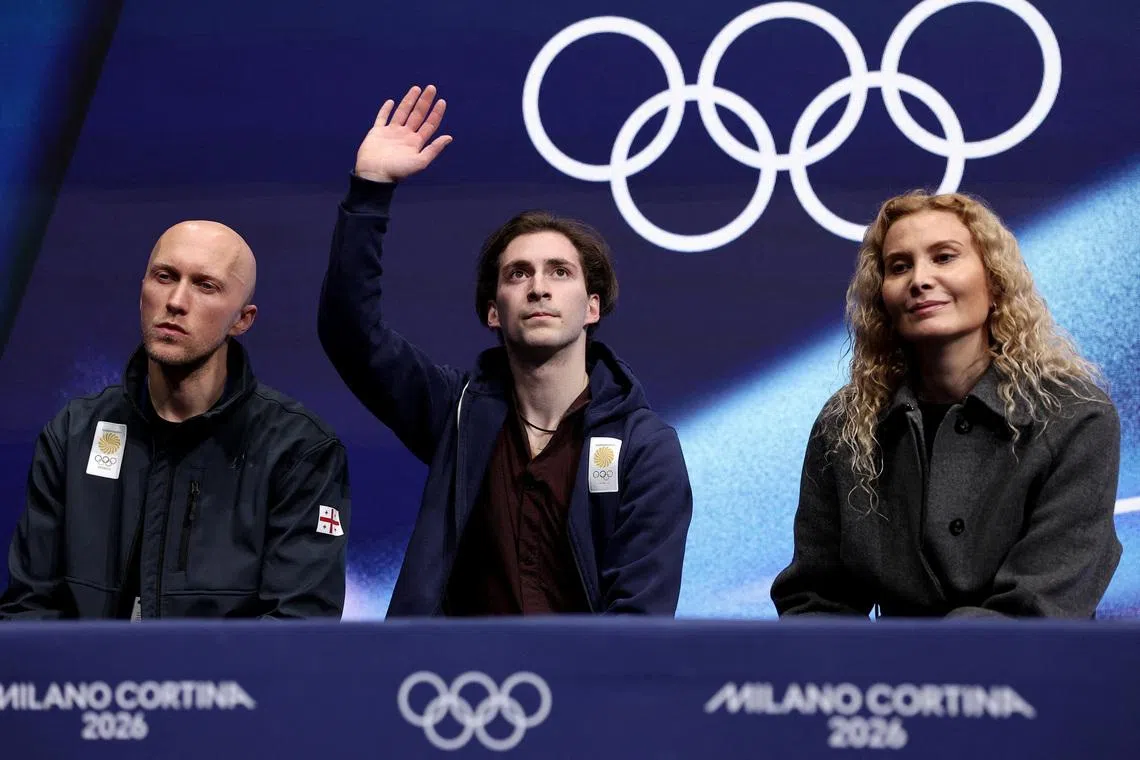 Milano Cortina 2026 Olympics - Figure Skating - Men Single Skating - Short Program - Milano Ice Skating Arena, Milan, Italy - February 10, 2026. Nika Egadze of Georgia with his coaches Eteri Tutberidze and Benoit Richaud after his performance during the Short Program REUTERS/Amanda Perobelli
