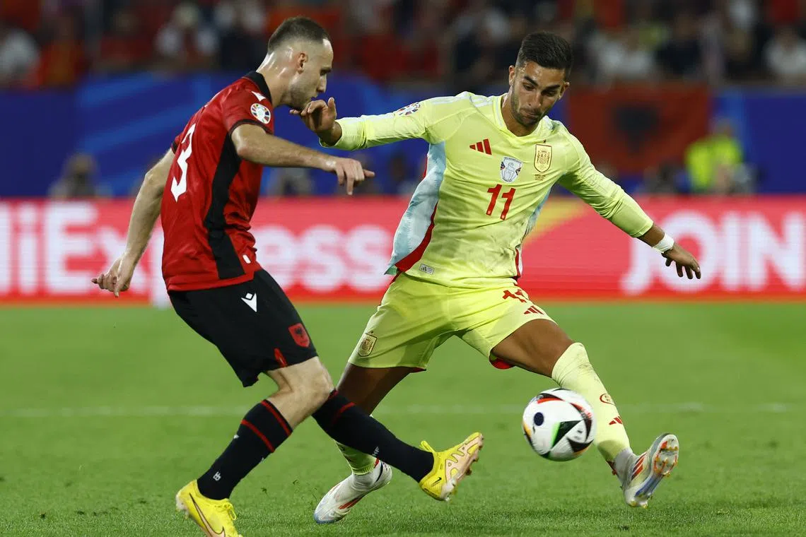 Soccer Football - Euro 2024 - Group B - Albania v Spain - Dusseldorf Arena, Dusseldorf, Germany - June 24, 2024  Spain's Ferran Torres in action with Albania's Mario Mitaj REUTERS/Piroschka Van De Wouw