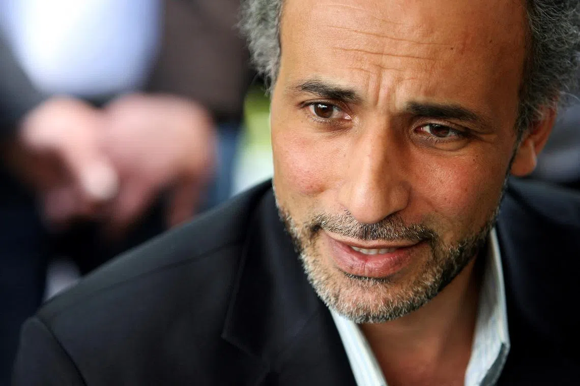 FILE PHOTO: Author Tariq Ramadan talks with a journalist after a conference at the Er-Rahma mosque in Nantes, western France, April 25, 2010. REUTERS/Stephane Mahe/File Photo