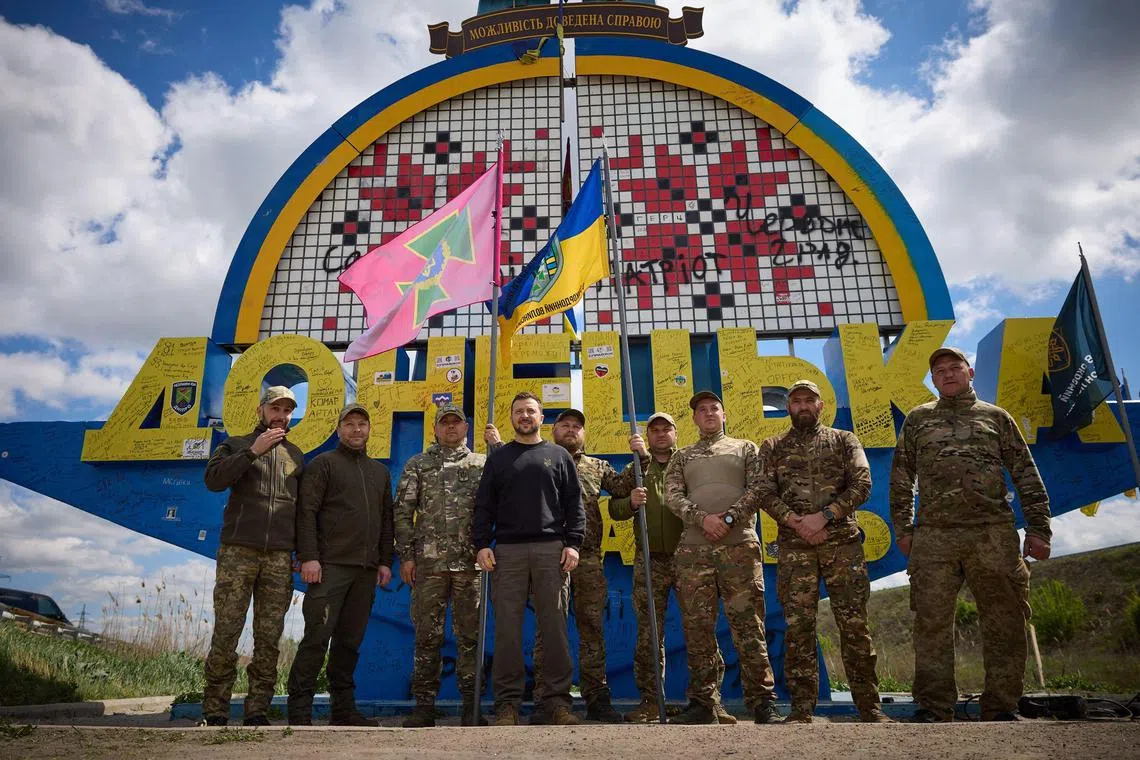 Ukrainian President Volodymyr Zelensky (centre left) during a recent visit to  Ukrainian soldiers in Ukraine's Donetsk region.
