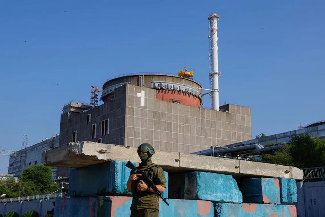 A Russian service member stands guard at a checkpoint near the Zaporizhzhia Nuclear Power Plant before the arrival of the International Atomic Energy Agency (IAEA) expert mission in the course of Russia-Ukraine conflict outside Enerhodar in the Zaporizhzhia region, Russian-controlled Ukraine, June 15, 2023. REUTERS/Alexander Ermochenko/File Photo