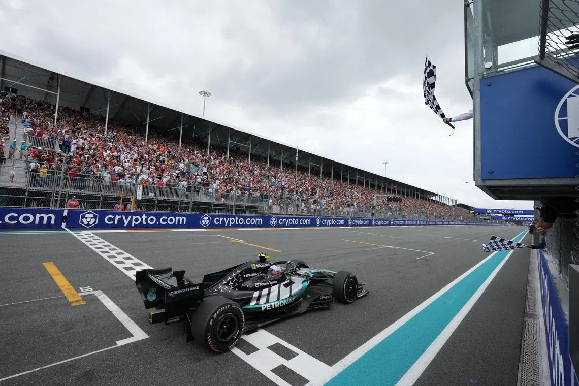 Formula One F1 - Miami Grand Prix - Miami International Autodrome, Miami, Florida, United States - May 3, 2026 Mercedes' Andrea Kimi Antonelli passes the chequered flag waved by former tennis player Rafael Nadal to win the Miami Grand Prix Pool via Reuters/Rebecca Blackwell