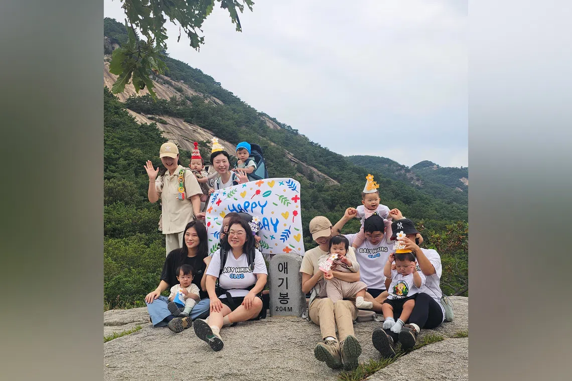 Members of the Baby Hiking Club pose for a photo at the Aegibong peak of Buramsan, in Namyangju, Gyeonggi Province, on Sept 9.