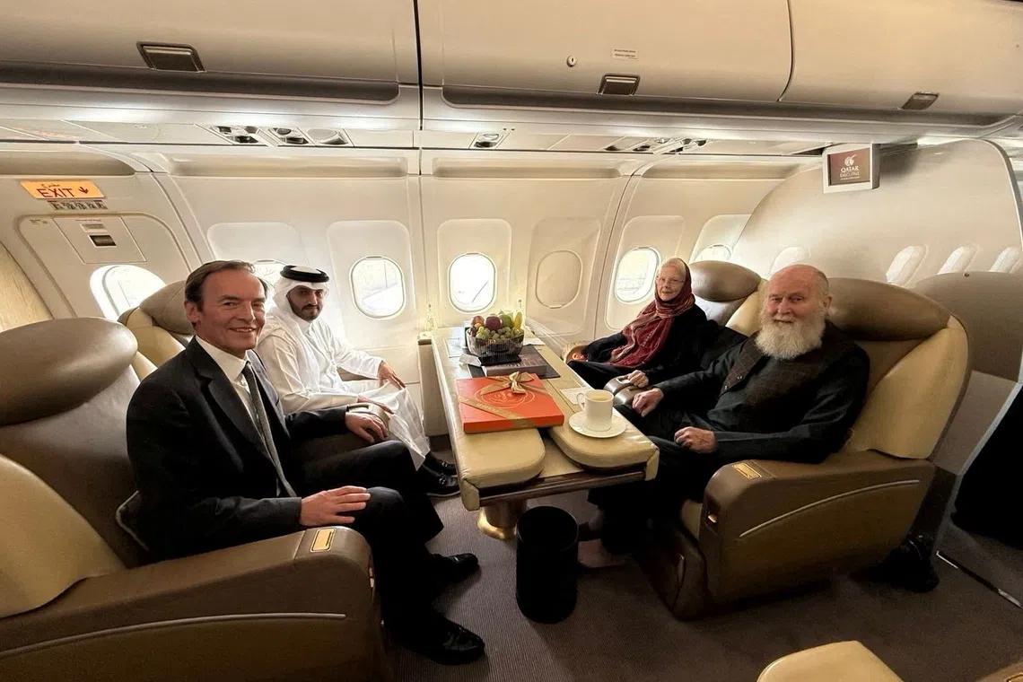 British citizens Peter and Barbara Reynolds (right), who had been in custody in Afghanistan, sit with Qatari and British diplomats on an aircraft on Sept 19, 2025.