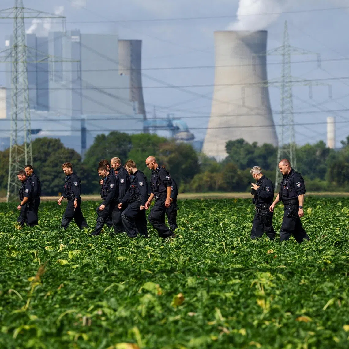 German police officers search a field near a power plant after a second sabotage attempt on Germany’s electricity grid, with local police saying they are investigating an attack on a substation in Bergheim, Germany.