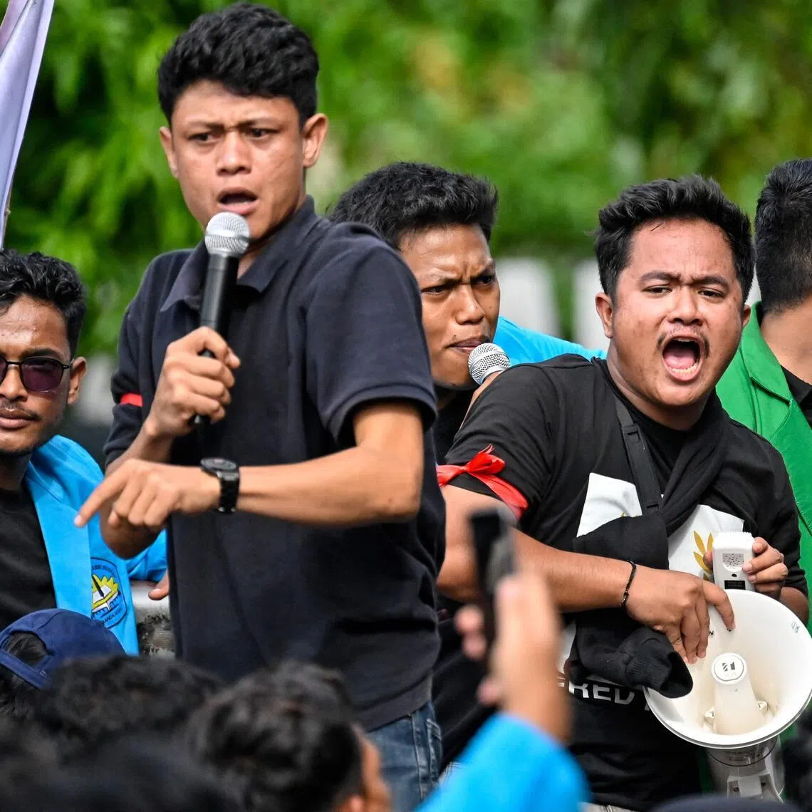 Activists hold a protest march over the government’s response to flooding in Sumatra that left over 1,100 people dead.

