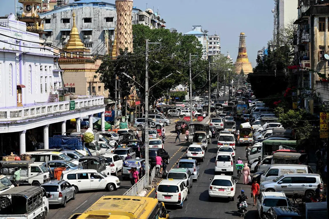 A general view shows traffic along Mahabandoola Road, with Sule Pagoda in the background, in Yangon on January 31, 2023. - Myanmar marks two years on February 1 since the military seized power, ousting the civilian government and arresting its de facto leader, Aung San Suu Kyi. (Photo by AFP)