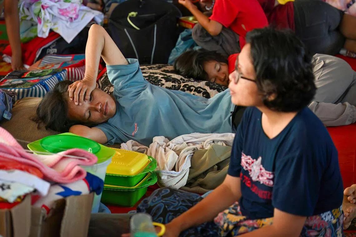 Villagers who lost their homes due to flash floods rest at a shelter at Tukka village in North Sumatra.