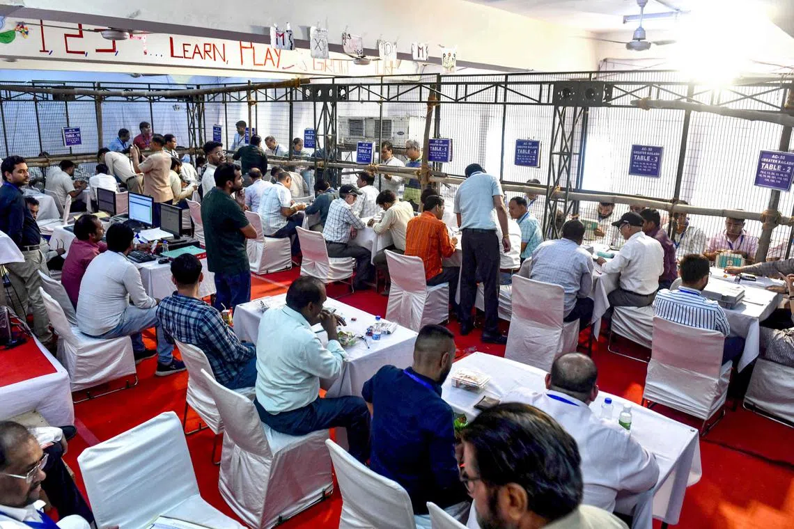 Polling officials tally votes at a counting centre in New Delhi on June 4.