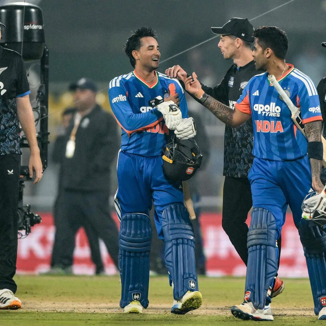 India's Abhishek Sharma (wearing gloves) and captain Suryakumar Yadav walk back to the pavilion after their team's win over  New Zealand in the third Twenty20 international at the Barsapara Cricket Stadium in Guwahati on Jan 25, 2026.