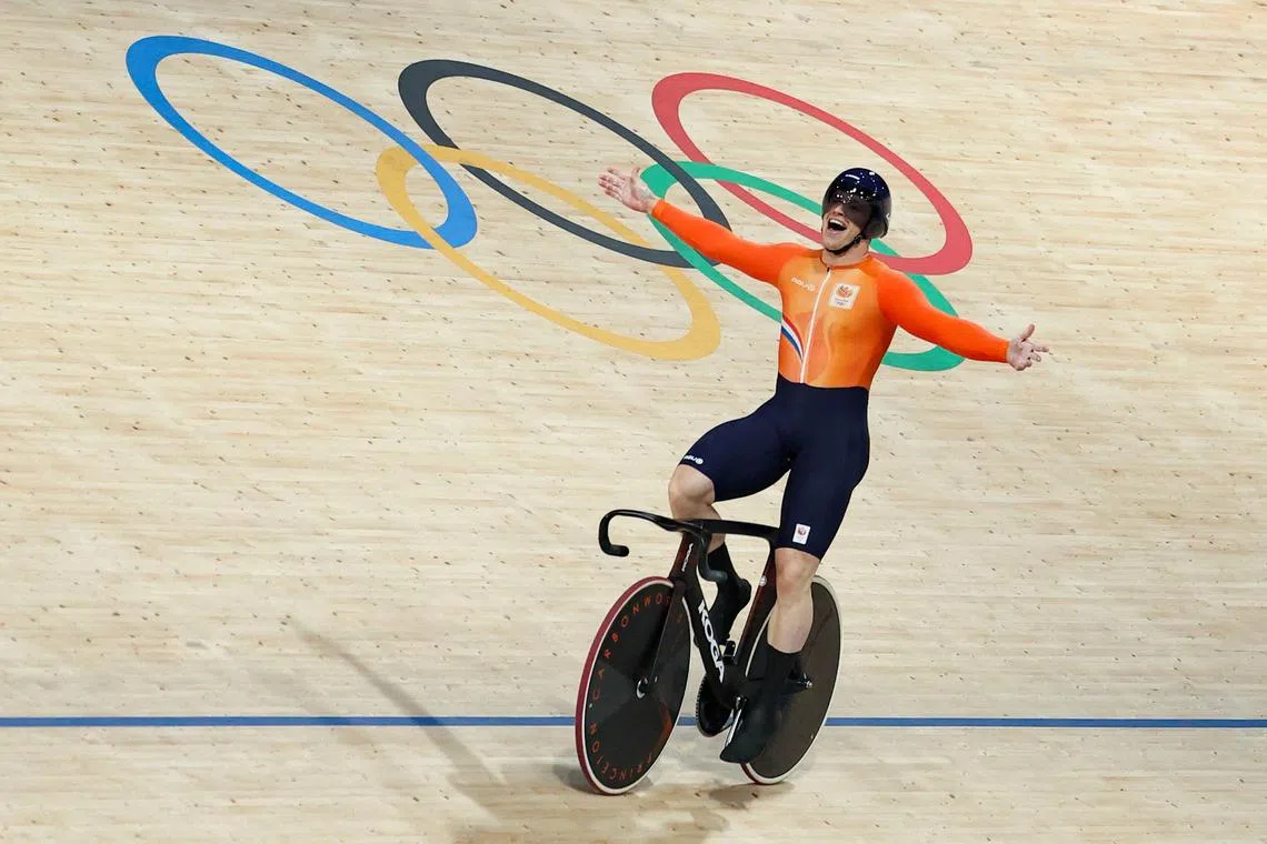 Netherlands' Harrie Lavreysen celebrates his team's victory after winning the men's track cycling team sprint final for gold.