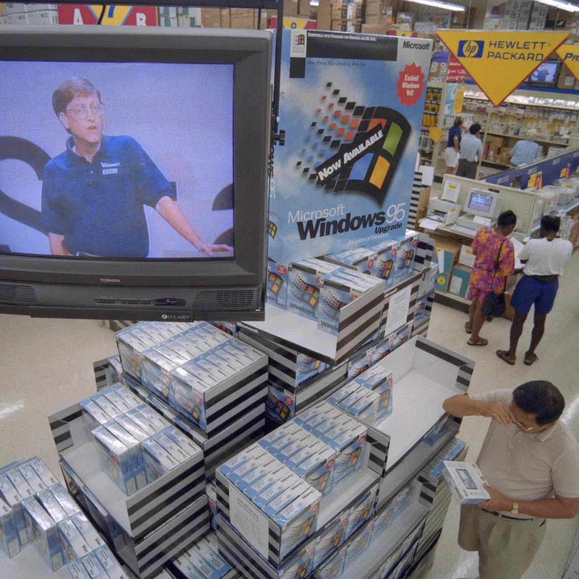 (FILES) Microsoft Corporation Chairman Bill Gates appears via television to promote his company's Window's 95 software at a Computer City Store in Vienna on August 24, 1995. Microsoft has been at the heart of computing for half a century, becoming a tech stalwart almost taken for granted as lifestyles embraced the internet. As the Redmond, Washington-based company founded with a vision of putting computers in every home and office celebrates its 50th anniversary on April 4, it looks to boost its fortunes by being a leader in artificial intelligence. (Photo by Paul J. RICHARDS / AFP)